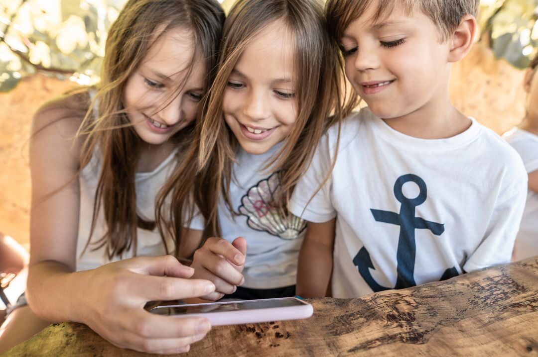 Phone scavenger hunt shown on a smartphone with a digital map, treasure route, and GPS markers for kids and adults